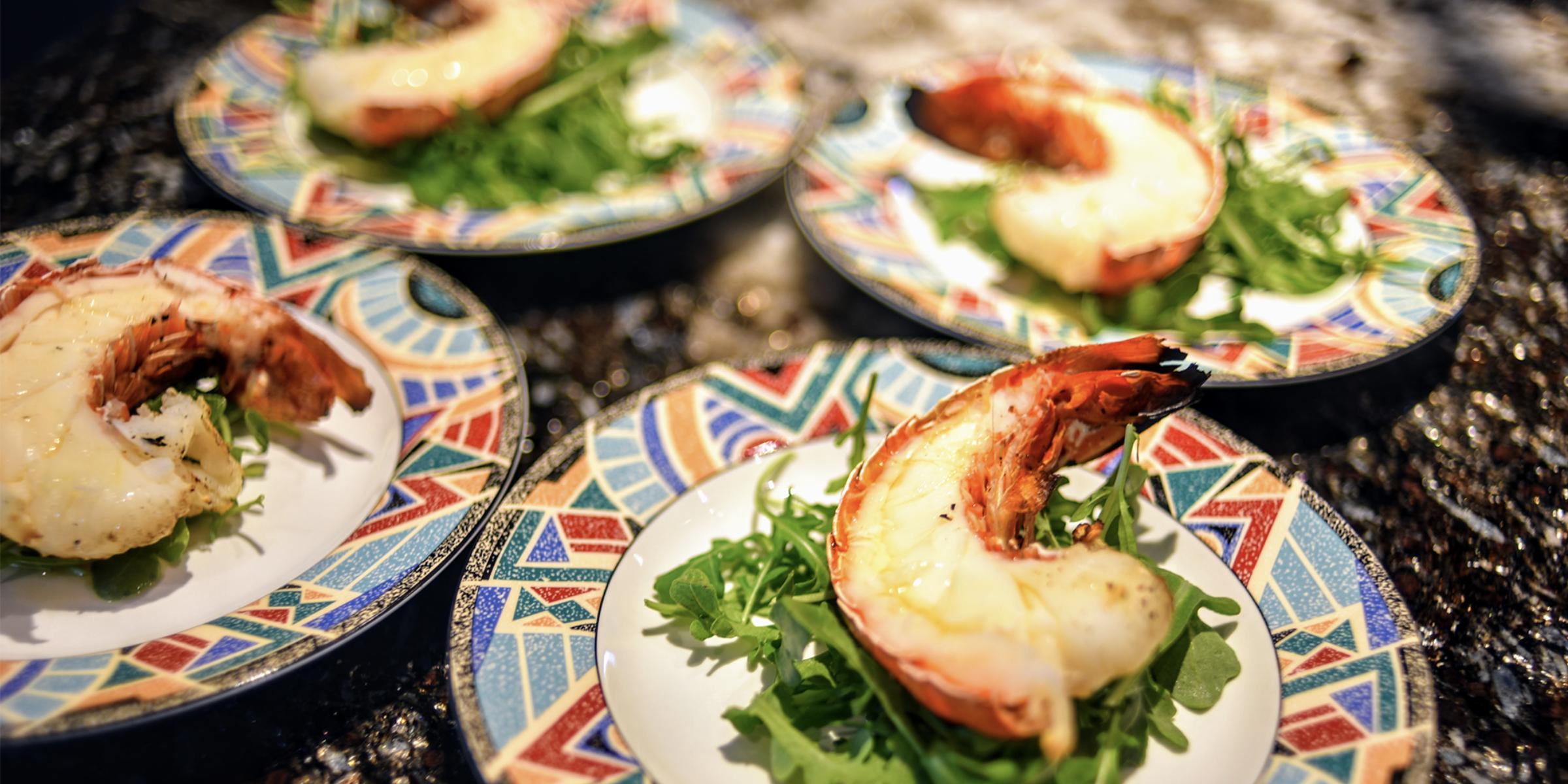 Gourmet lobster tail entree plated for a wedding reception